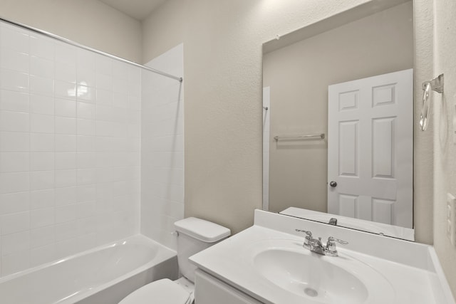 full bathroom featuring washtub / shower combination, vanity, and toilet