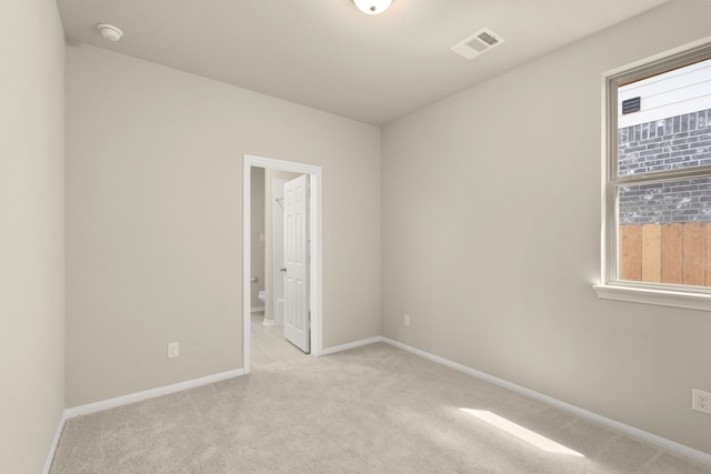 unfurnished room with light carpet