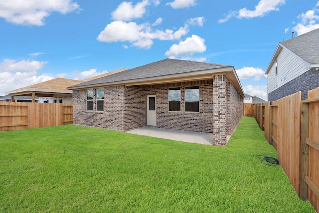 rear view of property with a lawn and a patio area