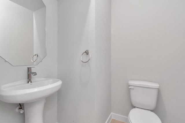 19726 Vino Vale Dr, Hockley, TX 77447 - bathroom with toilet, baseboards, and a sink