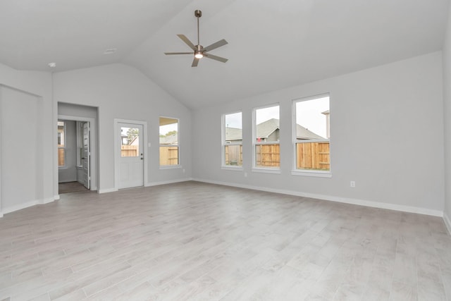 19726 Vino Vale Dr, Hockley, TX 77447 - unfurnished living room with a ceiling fan, light wood-style floors, baseboards, and high vaulted ceiling