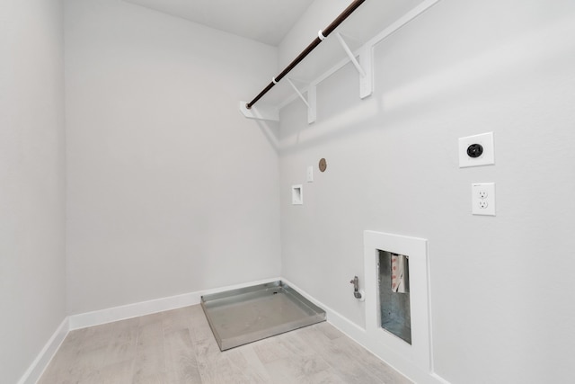 clothes washing area featuring washer hookup, hookup for an electric dryer, hookup for a gas dryer, and light wood-type flooring