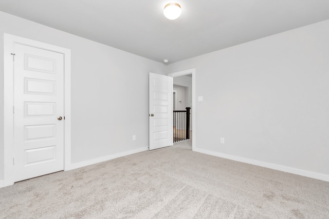 empty room featuring light colored carpet