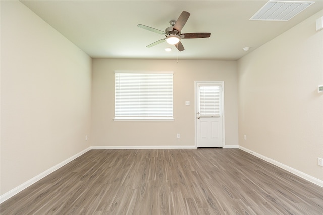 unfurnished room featuring hardwood / wood-style floors and ceiling fan