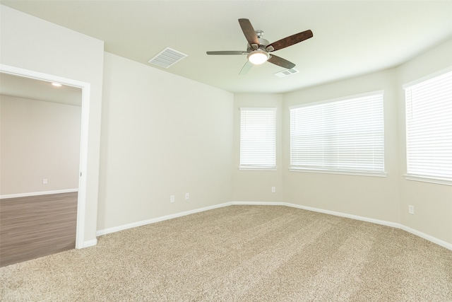 carpeted empty room featuring ceiling fan