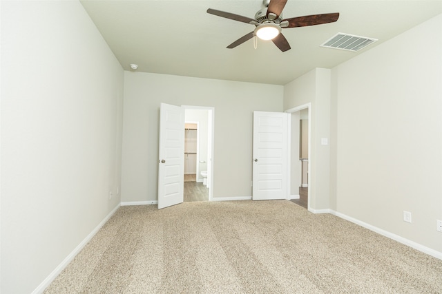 unfurnished bedroom featuring light carpet and ceiling fan