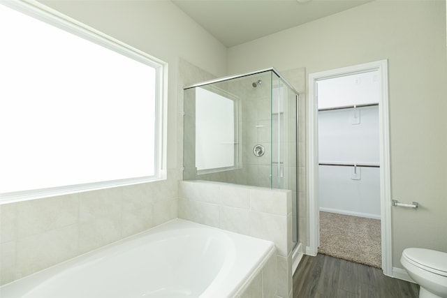 bathroom with independent shower and bath, hardwood / wood-style floors, and toilet