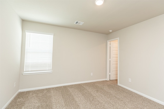 empty room with light colored carpet