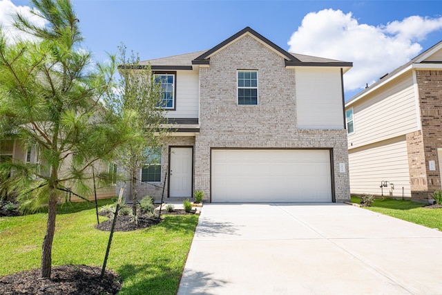 view of front of home with a garage and a front lawn