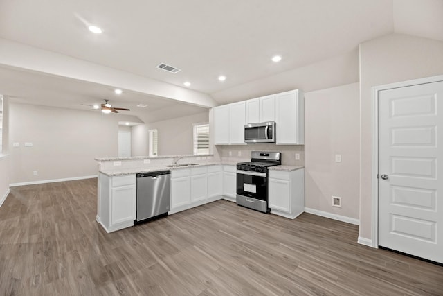 kitchen featuring kitchen peninsula, stainless steel appliances, white cabinetry, and sink