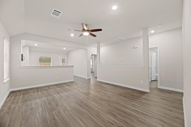 unfurnished living room featuring hardwood / wood-style flooring, ceiling fan, and lofted ceiling