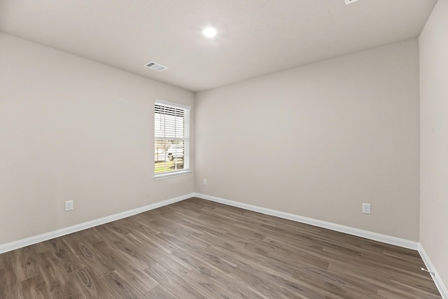 unfurnished room featuring dark hardwood / wood-style floors