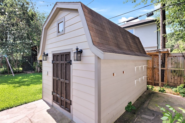 garage featuring wood walls and a yard