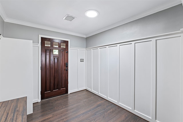 foyer entrance with ornamental molding and dark hardwood / wood-style floors