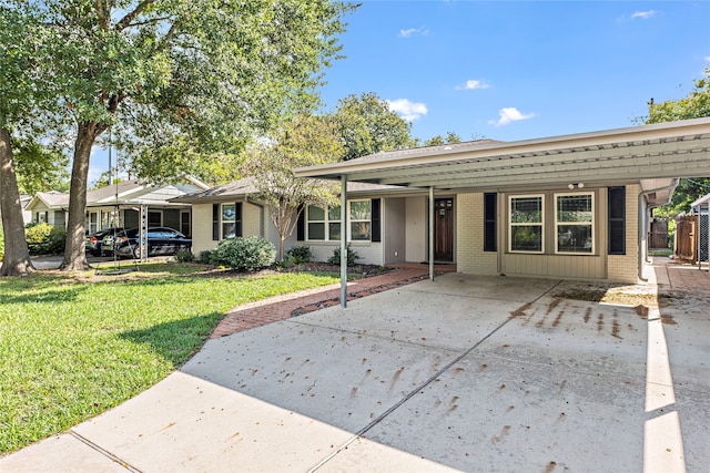 single story home featuring a carport and a front yard