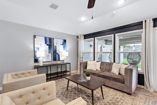 living room with light hardwood / wood-style floors and ceiling fan