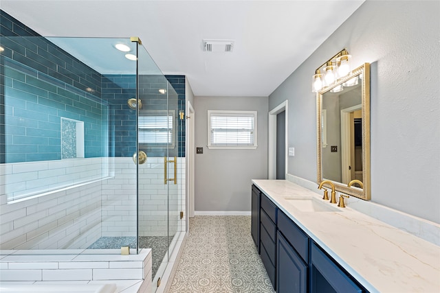 bathroom with tile patterned flooring, an enclosed shower, and vanity