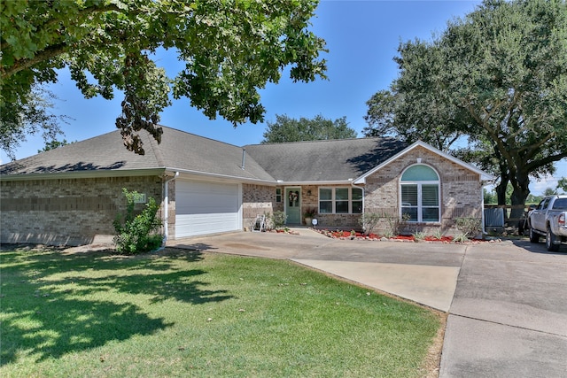 single story home featuring a garage and a front lawn