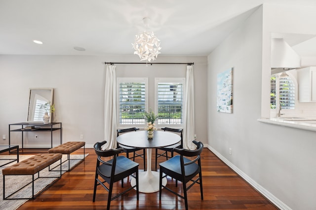 dining area featuring dark hardwood / wood-style flooring and a notable chandelier