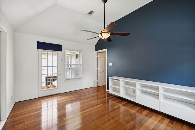 spare room featuring vaulted ceiling, ceiling fan, and dark wood-type flooring