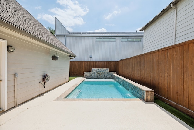 view of pool with a patio and pool water feature