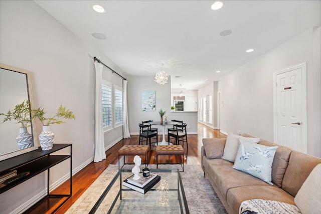 living room with wood-type flooring and a chandelier