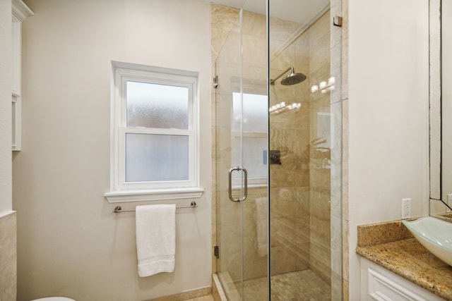 bathroom with an enclosed shower and vanity