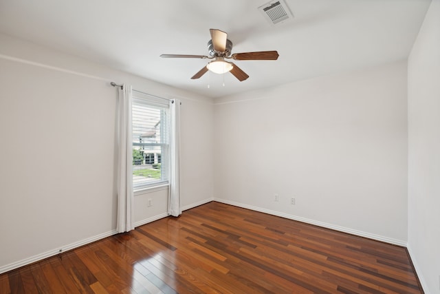 unfurnished room featuring ceiling fan and dark wood-type flooring