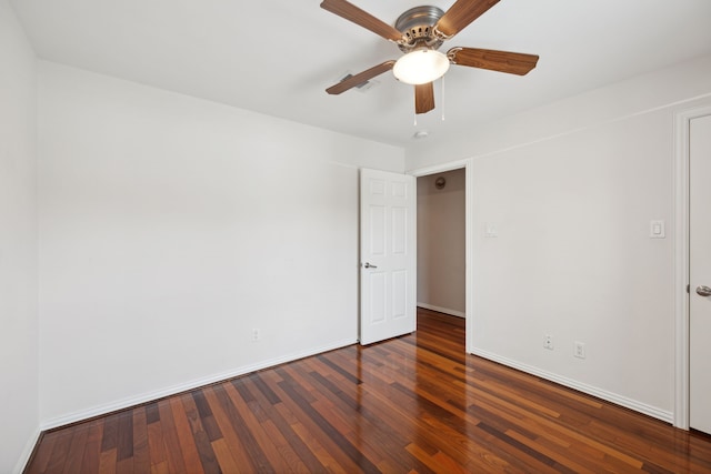 empty room with ceiling fan and dark wood-type flooring