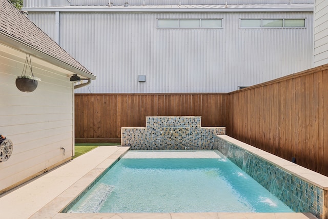 view of swimming pool with a patio and pool water feature