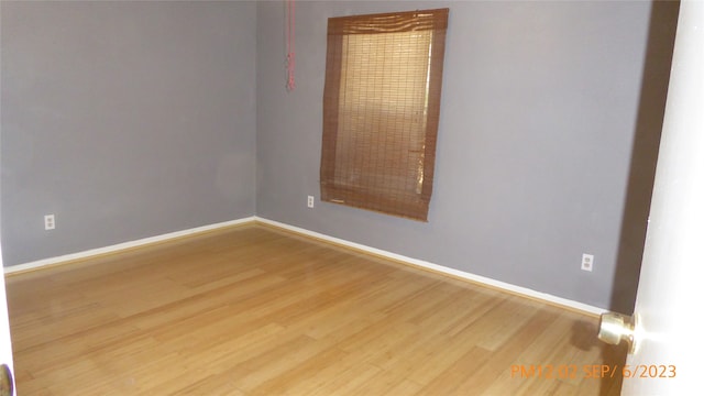 unfurnished room featuring hardwood / wood-style flooring