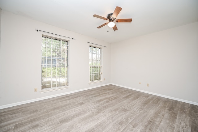 empty room with light wood-type flooring and ceiling fan