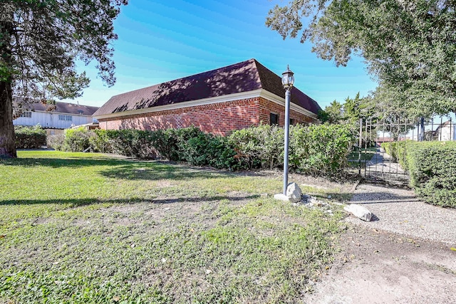 view of side of property with a lawn