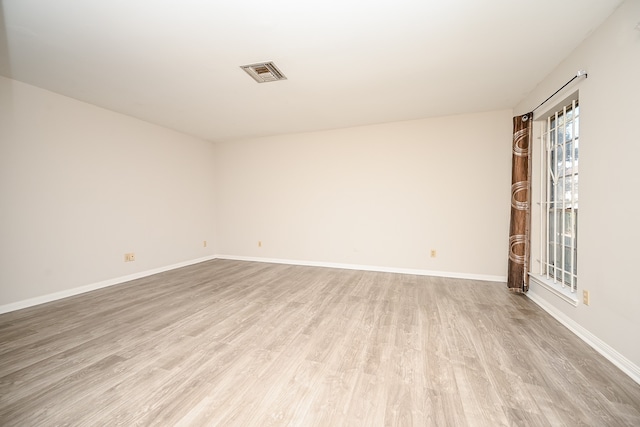 empty room with light hardwood / wood-style floors