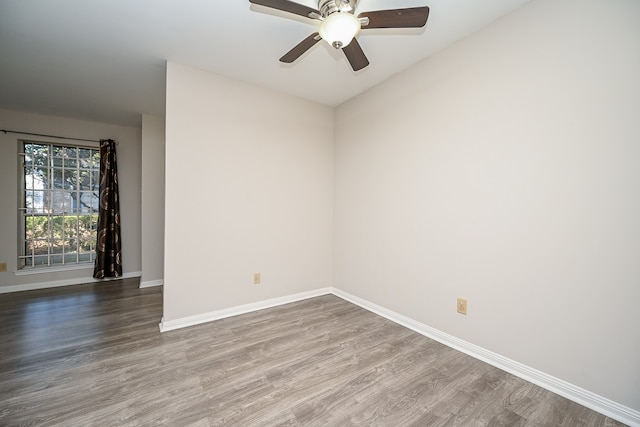 empty room featuring hardwood / wood-style floors and ceiling fan