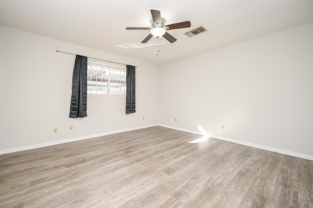 empty room with ceiling fan and light hardwood / wood-style floors