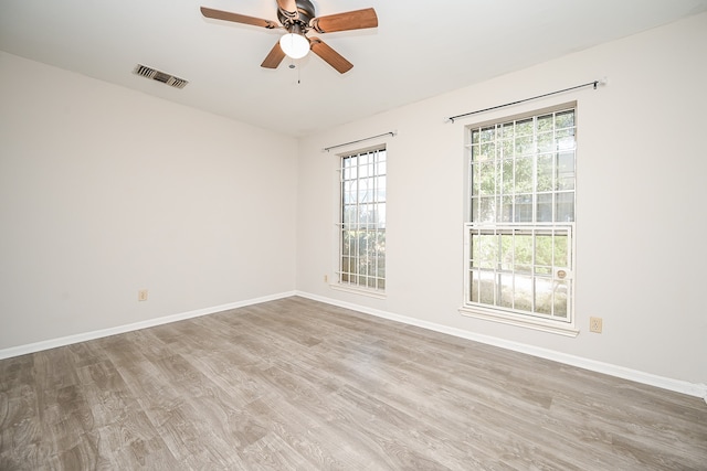 empty room featuring light wood-type flooring and ceiling fan