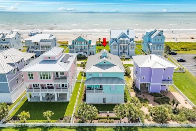 birds eye view of property with a water view, a residential view, and a view of the beach