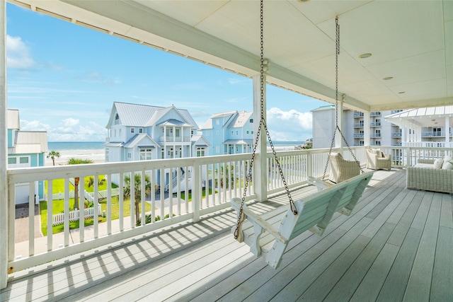 deck featuring outdoor lounge area and a water view