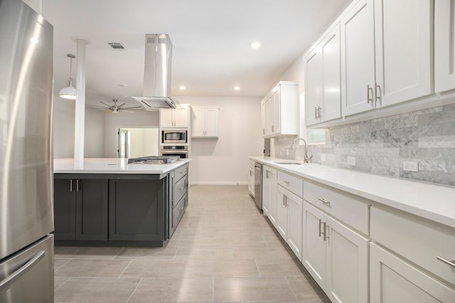 kitchen with white cabinets, island exhaust hood, and appliances with stainless steel finishes