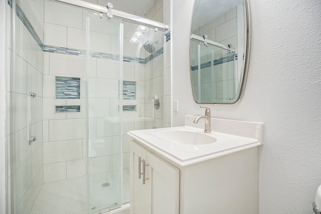 bathroom featuring walk in shower and vanity