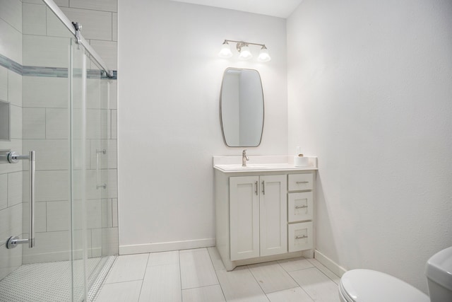 bathroom featuring vanity, toilet, and a shower with door