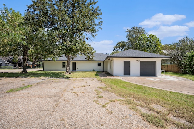 ranch-style home with a front yard and a garage