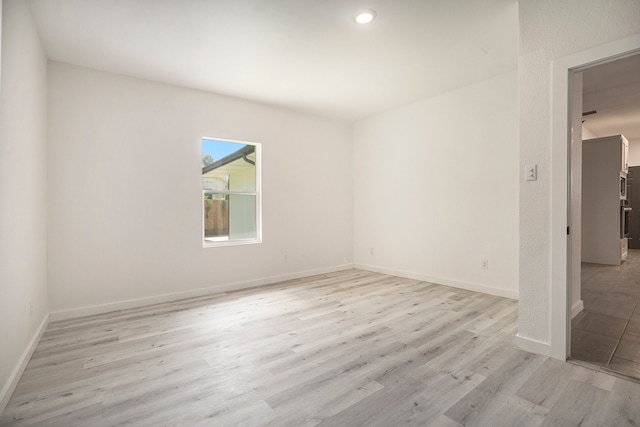 unfurnished room with light hardwood / wood-style flooring