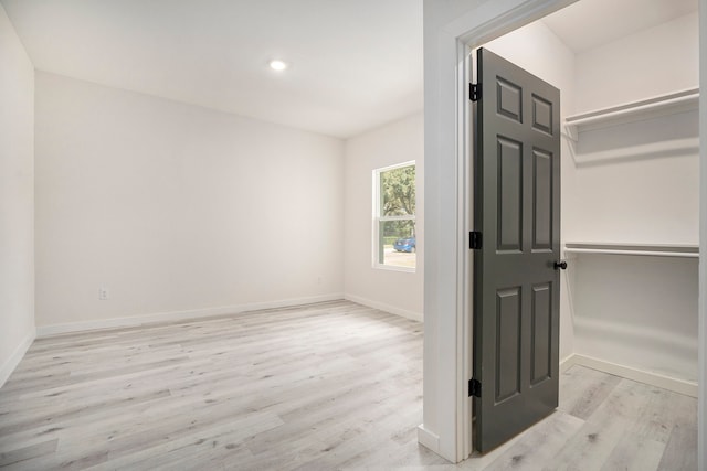 interior space with light wood-type flooring and a closet