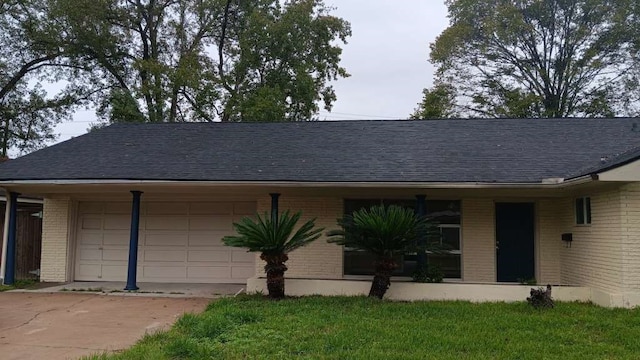 single story home featuring a garage and a front yard