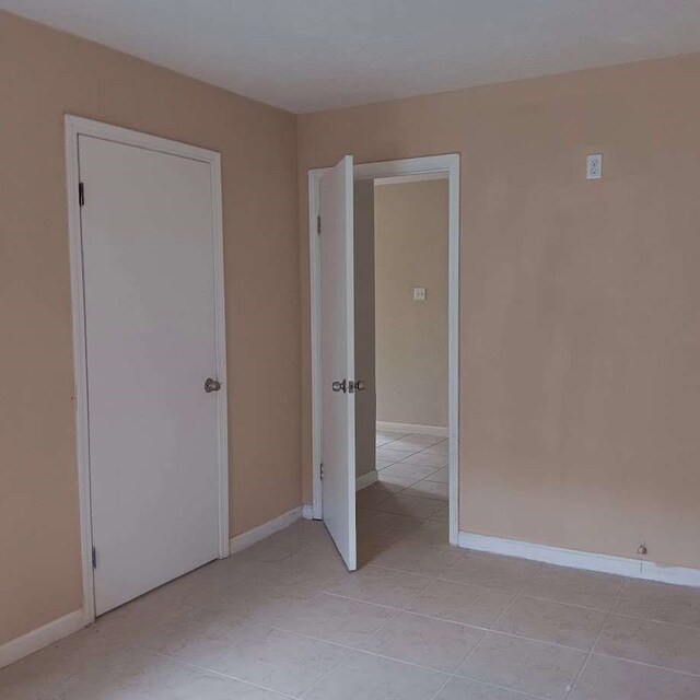 unfurnished bedroom featuring light tile patterned flooring