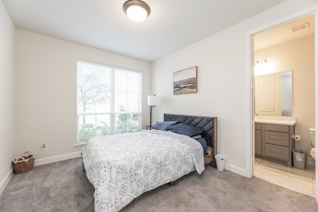 carpeted bedroom with connected bathroom