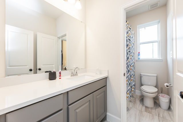 bathroom with vanity and toilet