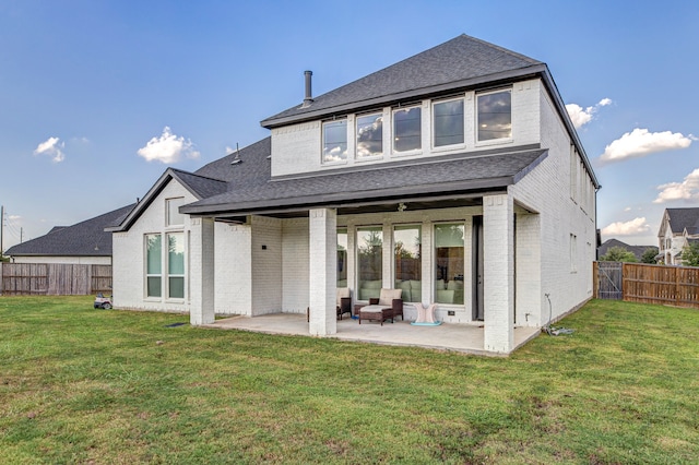 rear view of property featuring a patio area and a lawn